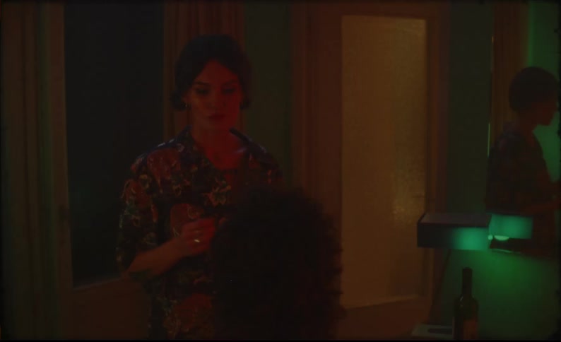 A couple have drinks and kiss