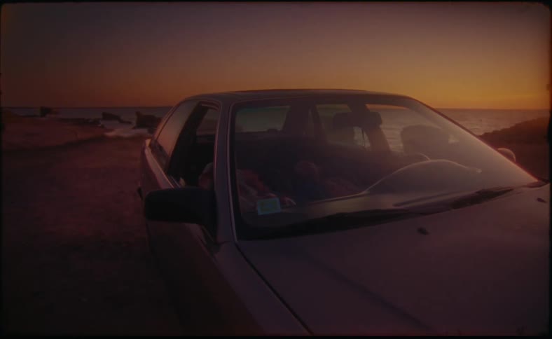 A car is parked on the beach