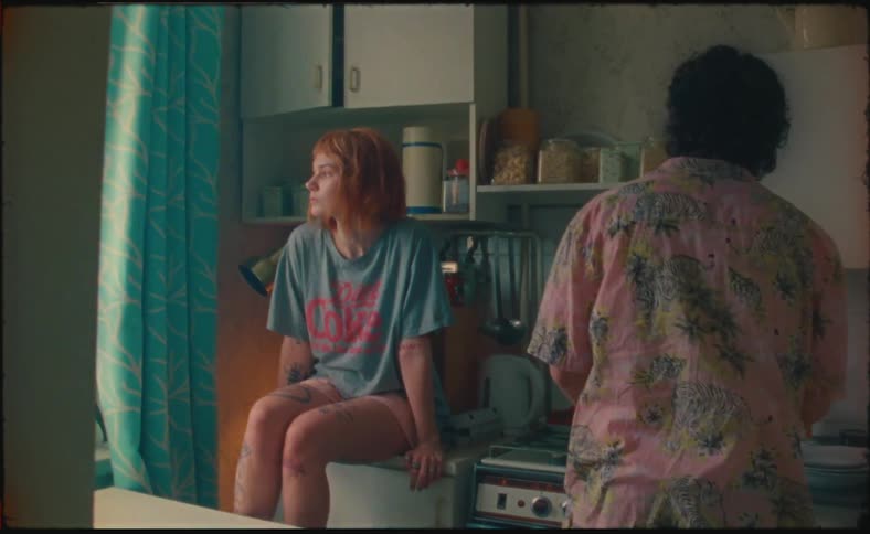 Two people in a kitchen hanging out