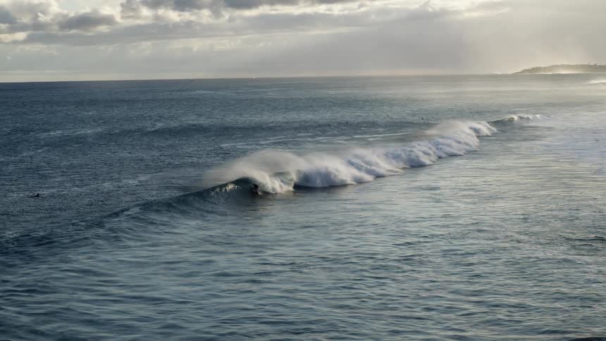 A small wave moves through the ocean