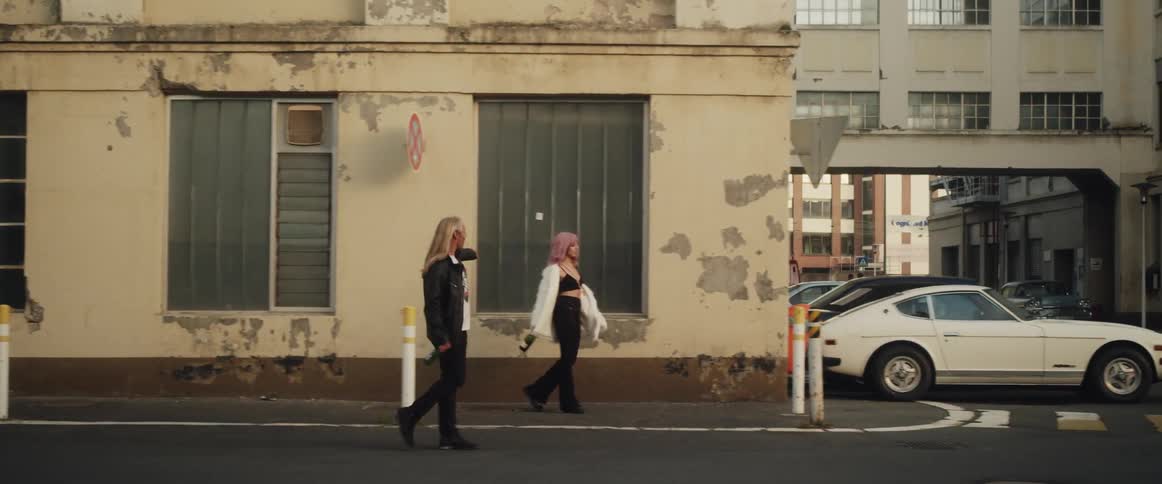 Two people walking down the road
