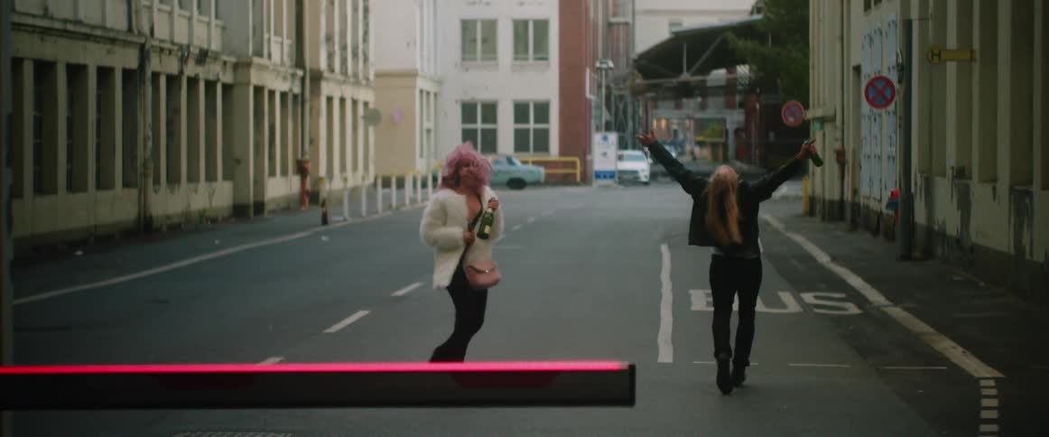 Two people running down the road