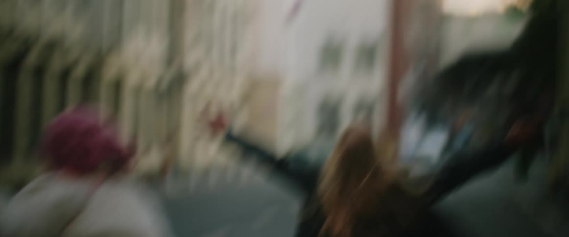 Young couple running on the empty city streets at morning after a party
