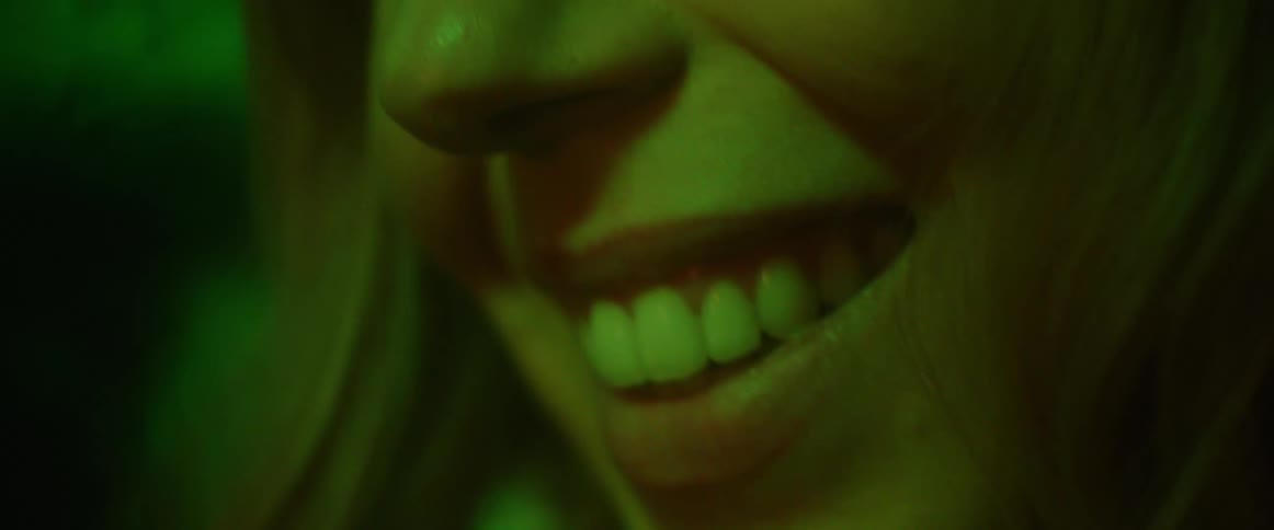 A young white woman is smiling and seems very happy