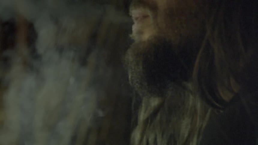 A person lights their cigarette and takes a drag
