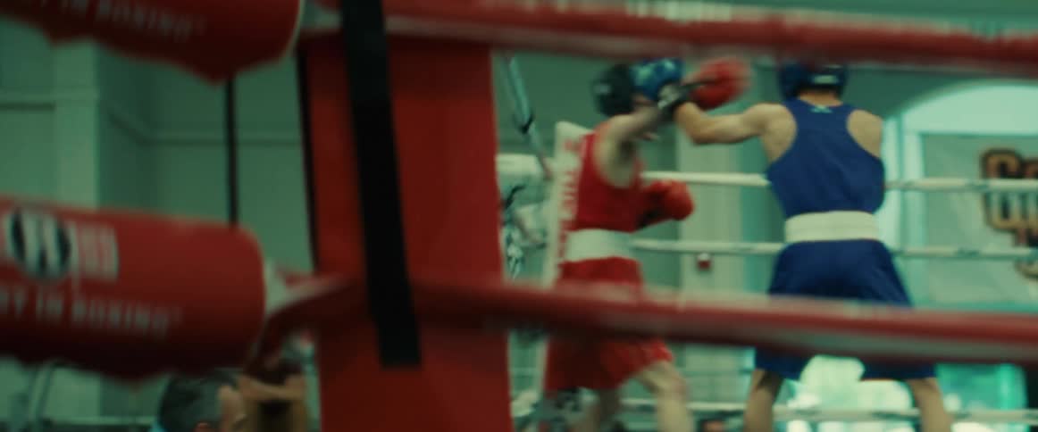 Two men spar in the boxing ring