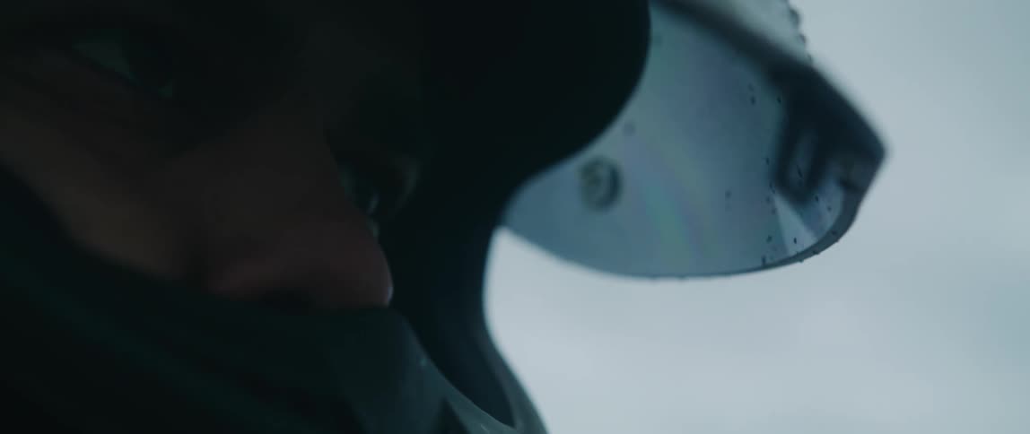 A man opens the visor on his motorcycle helmet