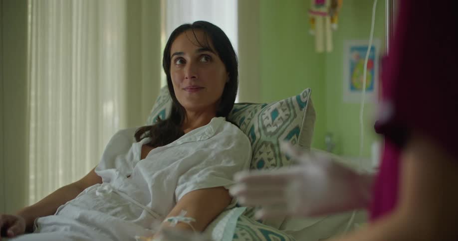 There is a patient inside of a hospital talking to a nurse