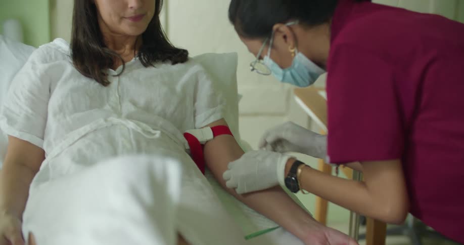 There is a patient laying inside of the hospital in the middle of the day