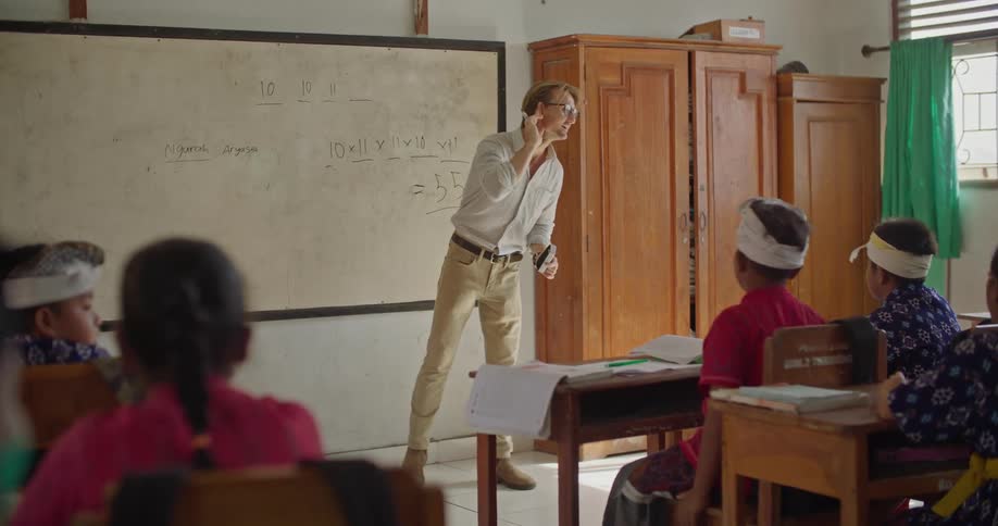 Teacher indicates they cannot hear the one speaking while lecturing in classroom
