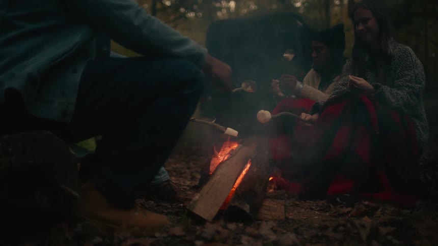 People making smores outdoors