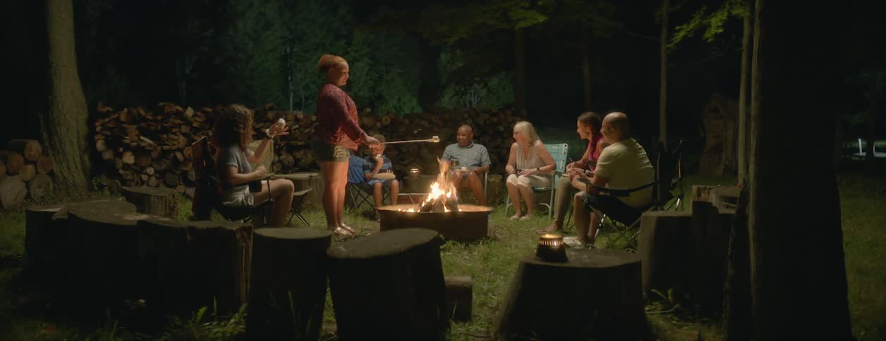 People sit around the campfire