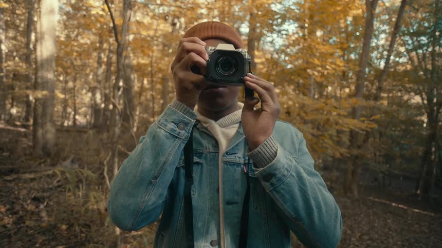 A person taking photos in a forest