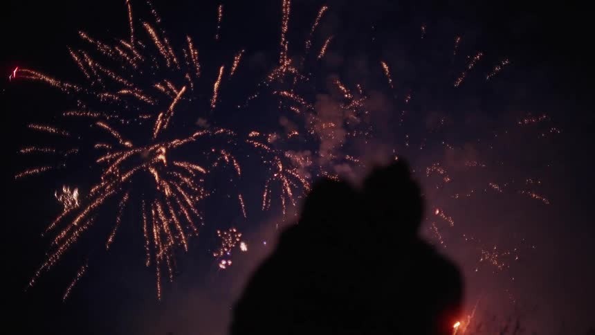 A couple watch the fireworks