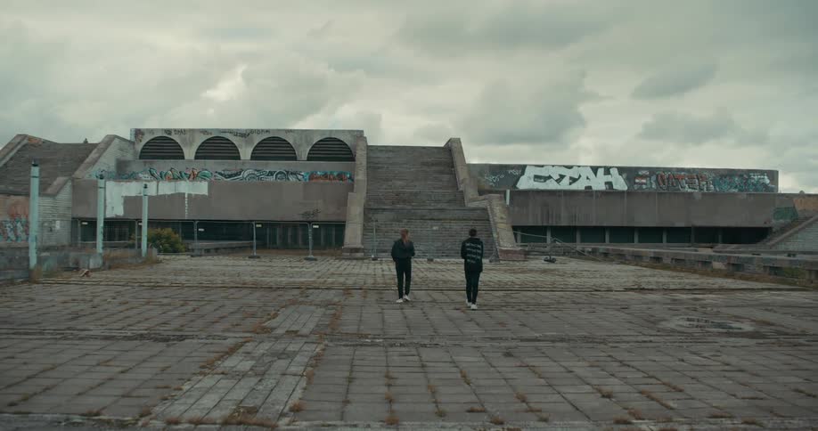 Two people walking towards a building