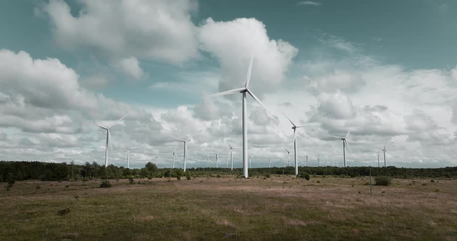 Wind turbines spin in a wide open field