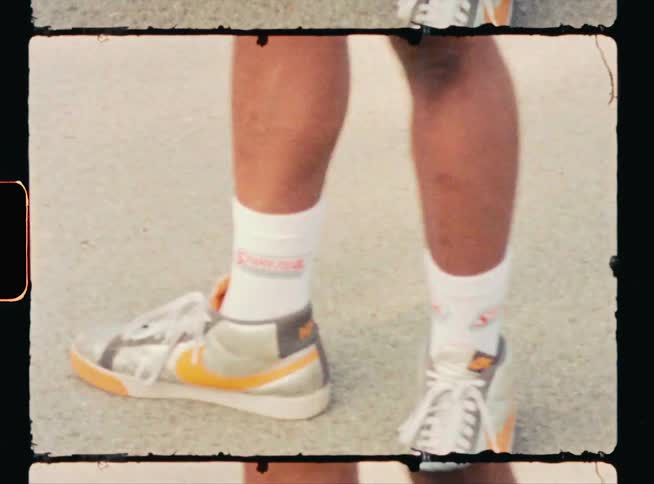 Vintage footage of a mans legs as he skateboards