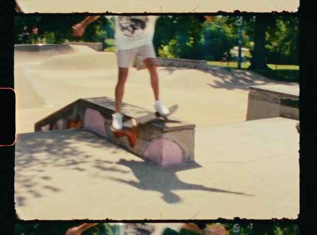 A man rides a skateboard on a ramp in a skate park