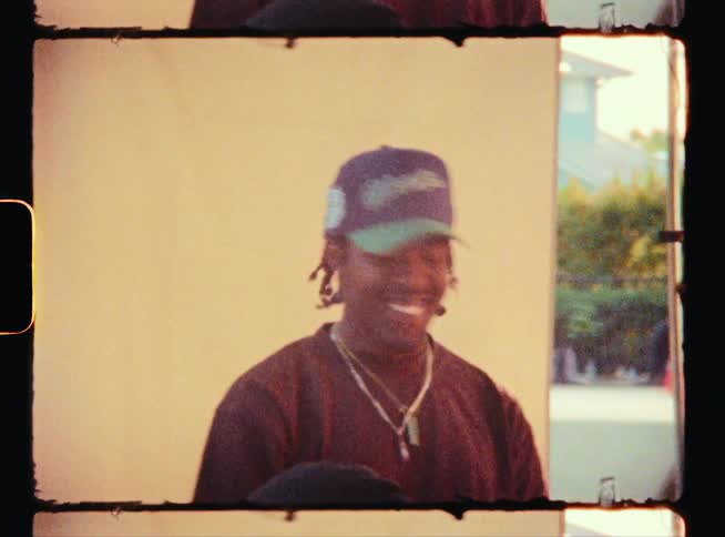 Vintage footage of a man turning his head and smiling at someone