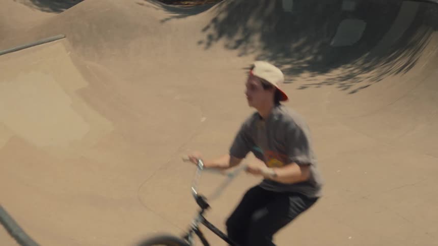 A boy is riding a bike outdoors during spring