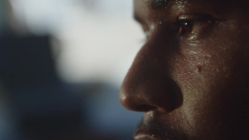 Man with sweaty face breathes deeply