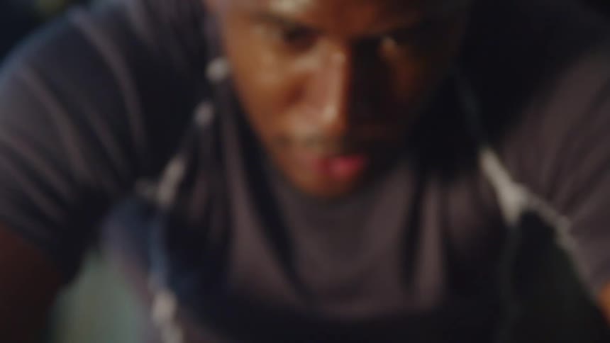 A young black man is working out in the middle of the daytime