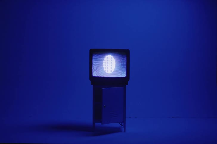 An egg shape plays against static on a television screen