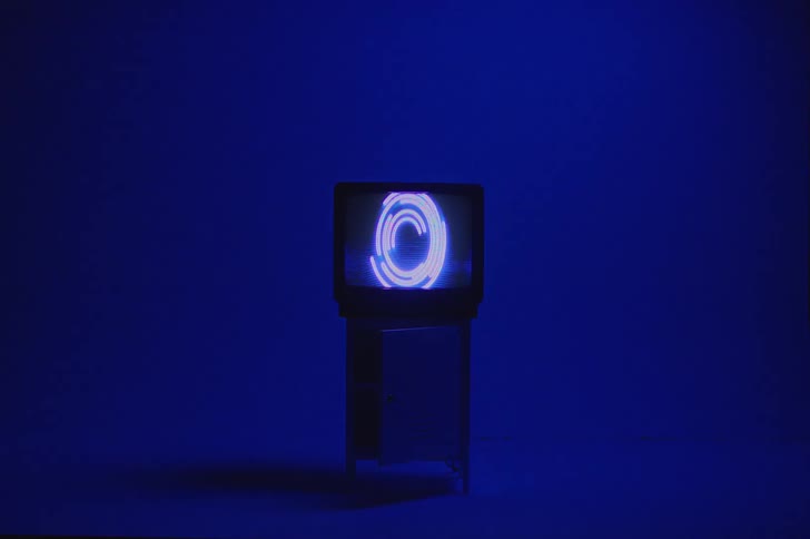 A television screen is set on a cabinet indoors