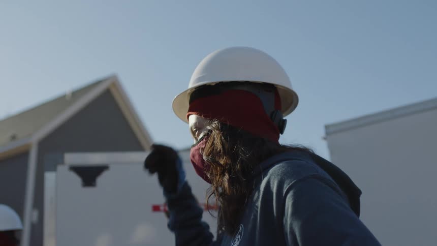 A young woman is working as a constructor in the day time