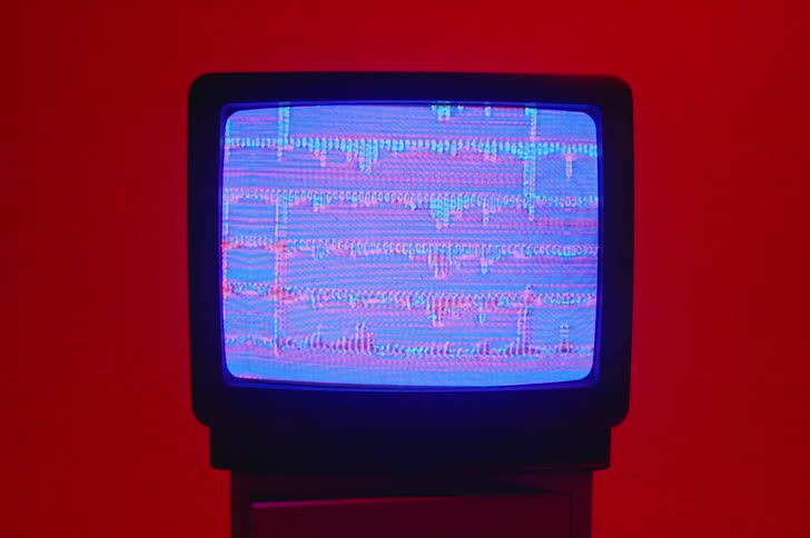 There is a television screen that is in a room