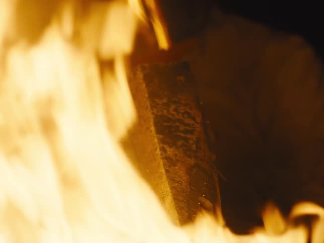A person is using a forge