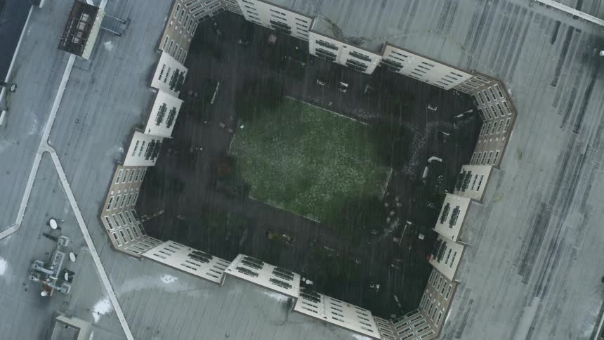 Aerial view of a city while its raining is displayed