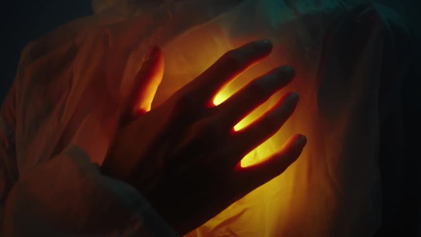 A person hands is touching their chest