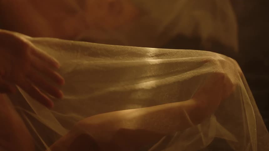 A person is moving their hands with a blanket covering them