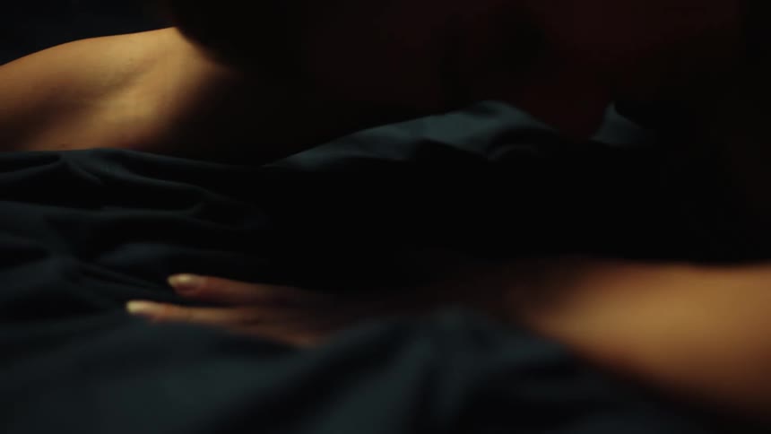 There is a young white woman that is laying in the bed