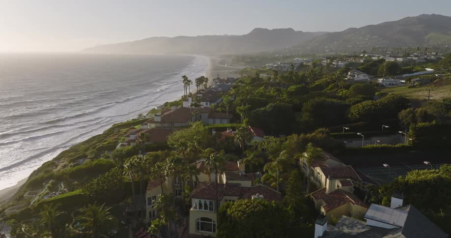 Aerial view of houses near an ocean beach is displayed