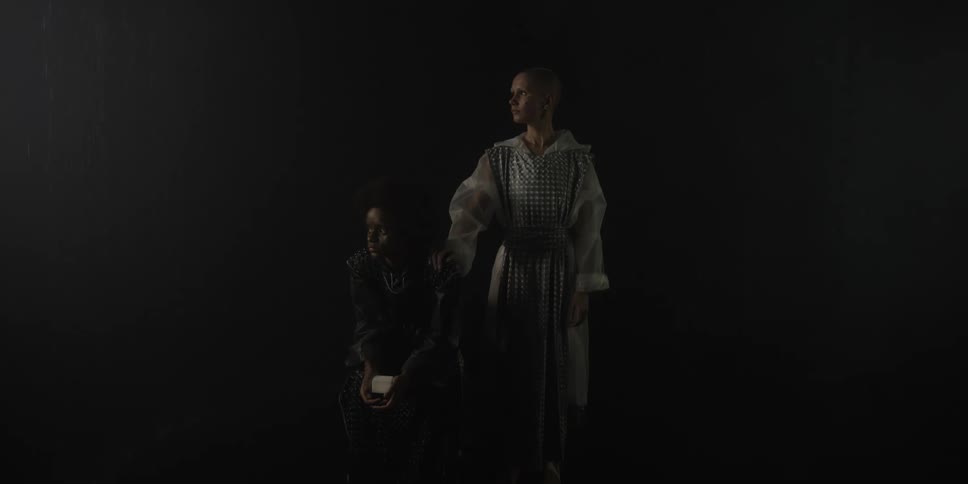 Two people are standing near each other in this portrait