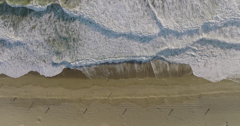 The waves crash against the shore