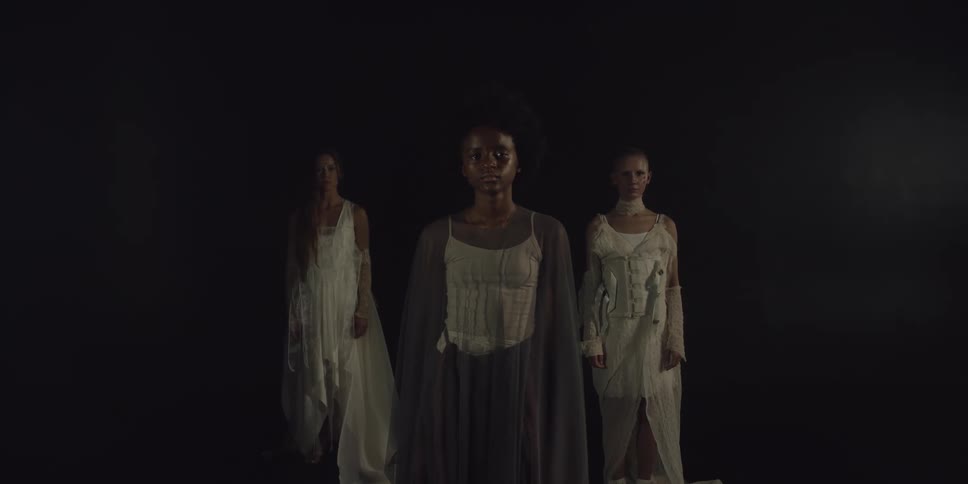 Three women are posing for the portrait together