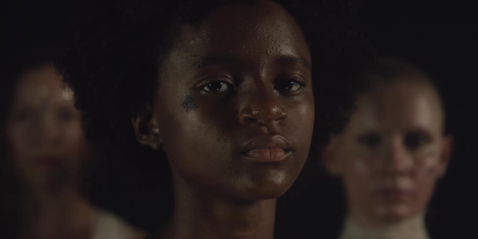 A woman turns her head in the dark