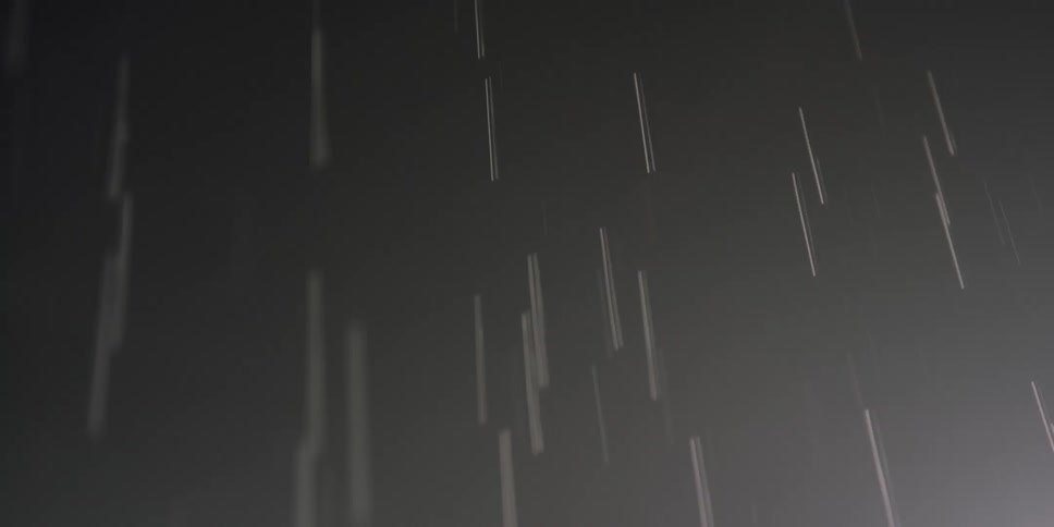 Pale lines flow against a dark gray background before blurring