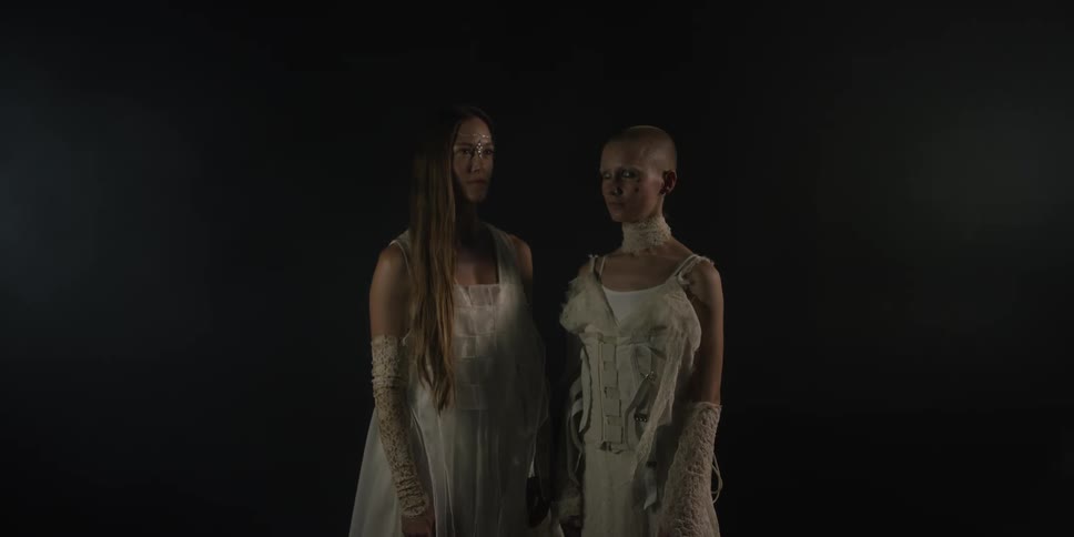 Two women are standing next to each other in this portrait