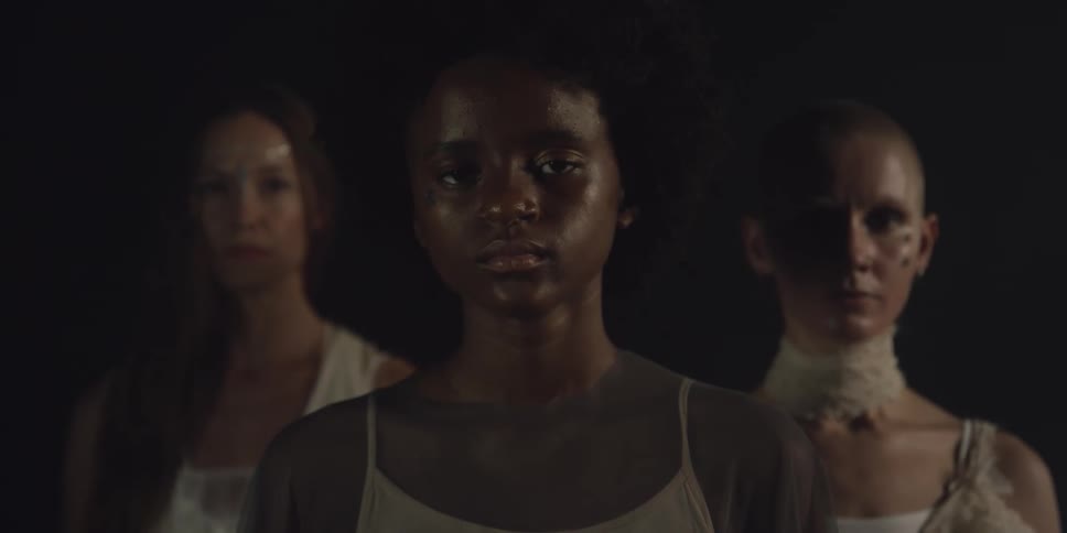 Three women stand together