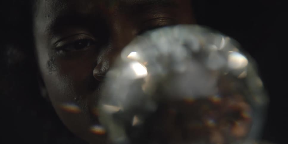 A model poses with a shimmering orb