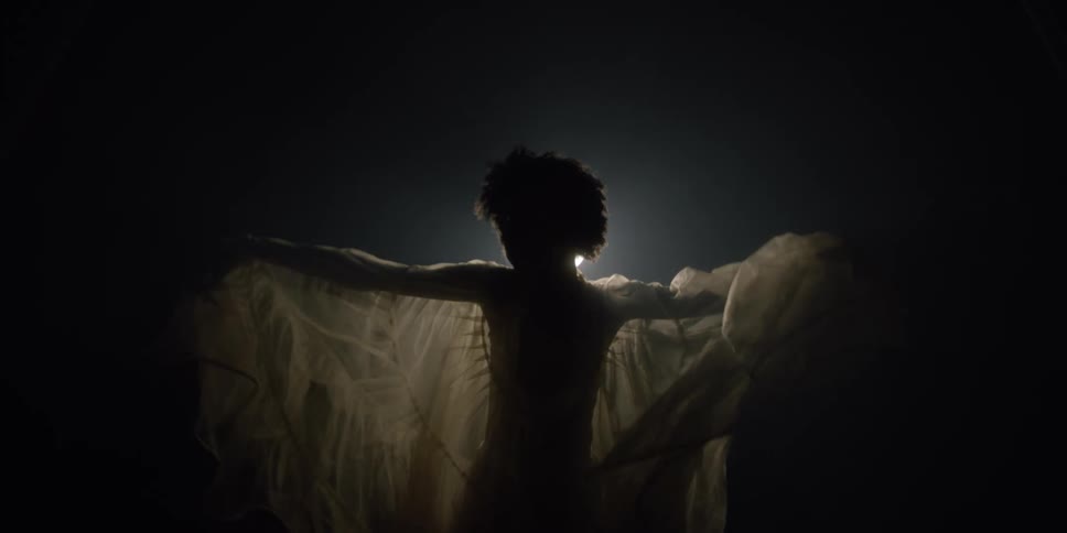 A woman is spinning around dancing