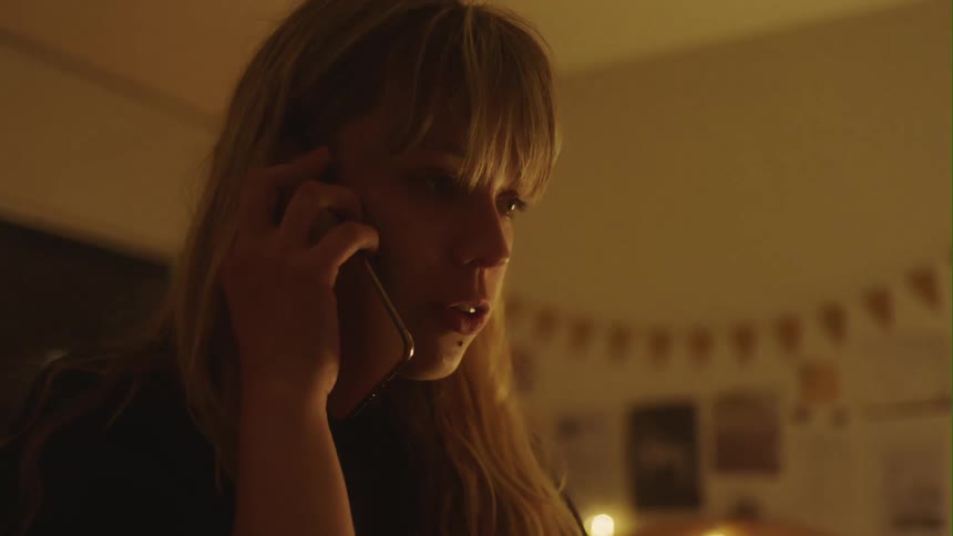 An upset teenager talks on a cell phone