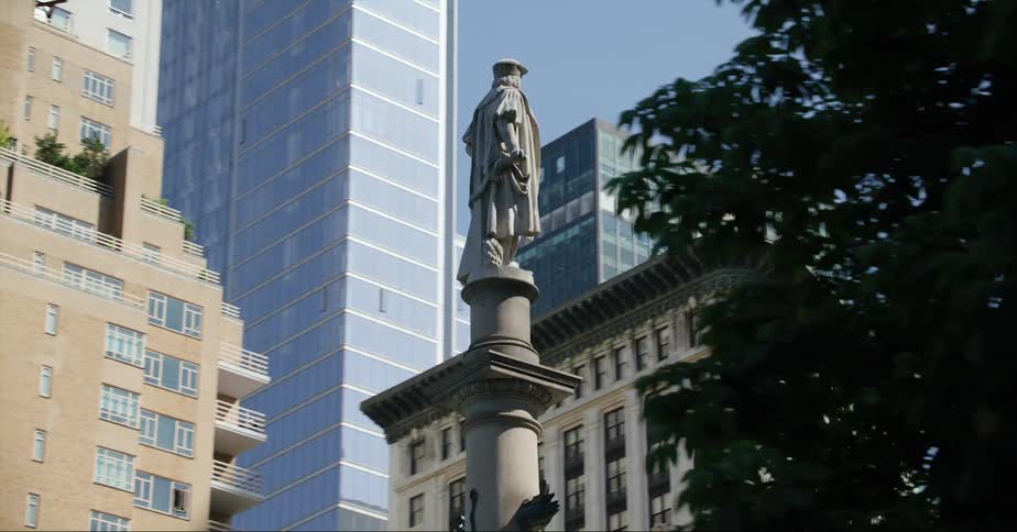 Statue erected in city square surrounded by high rise buildings