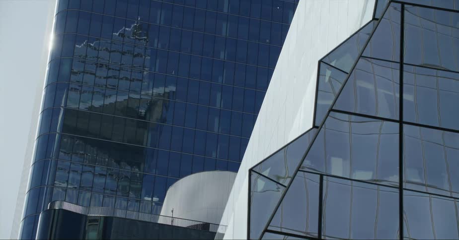 Tall glass skyscrapers towering overhead in the daytime