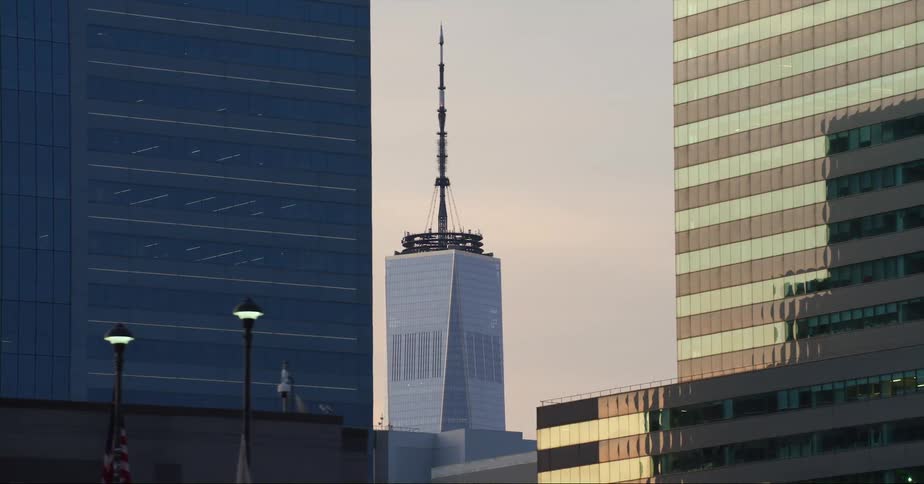 Top of the one world trade center in new york city between skyscrapers at evening