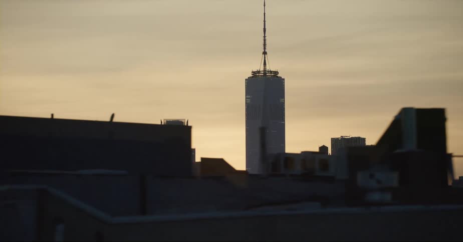 The sun is setting in a downtown city